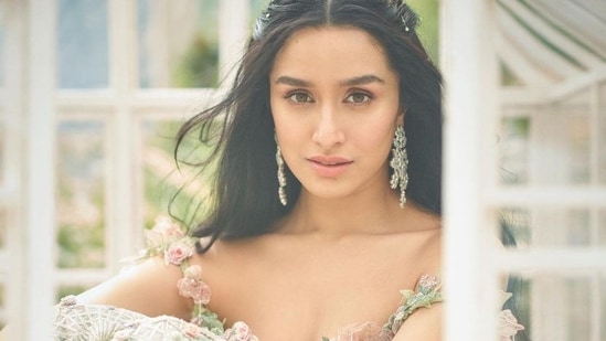 Taking to his social media handle, Rohan shared a slew of pictures featuring Shraddha seated inside a tiny glass house in the backdrop of a greenhouse and donning a strappy green crop top that was brought to life with 3D flowers growing across it as they would in a rose garden while golden tassels lined the hem.&nbsp;(Instagram/rohanshrestha)