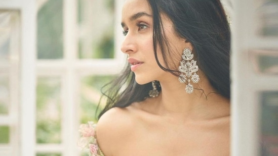 Leaving her luscious tresses open down her back in mid-parted hairstyle and adorned with ferns, Shraddha accessorised her look with a pair of statement floral shaped earrings from Vanraj Zaveri.&nbsp;(Instagram/rohanshrestha )