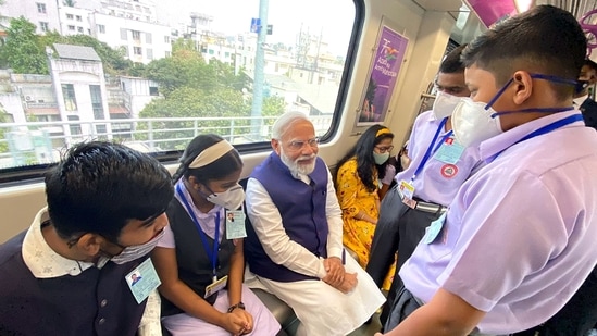 Prime Minister Narendra Modi rides in Pune Metro with the school children after inaugurating it, in Pune. (ANI)