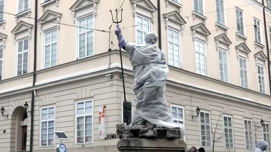 A view of a covered statue amid the Russia-Ukraine war at Rynok Square, in Lviv on Sunday.(ANI)