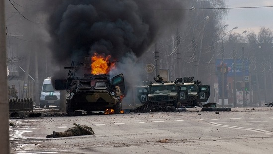 A Russian armored personnel carrier burns amid damaged and abandoned light utility vehicles after fighting in Kharkiv, Ukraine.(AP)