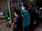 A woman leaves after casting her vote as others wait for their turn at a polling station during the last phase of state assembly election in Varanasi in the northern state of Uttar Pradesh, India, March 7, 2022. REUTERS/Adnan Abidi
