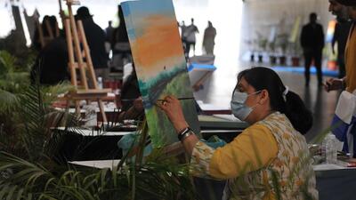 An artist during an art workshop organised as part of the Iconic Week at the pedestrian underpass connecting Rose Garden in Sector 16 to Sector 17 in Chandigarh on Monday. (Ravi Kumar/HT)