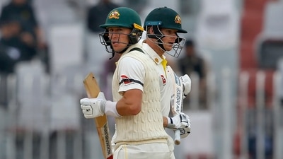 Marnus Labuschagne, front, and Steve Smith run between the wickets during the 3rd day of the first cricket test match between Pakistan and Australia in Rawalpindi (AP)