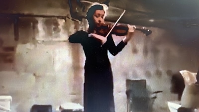 The girl plays violin inside a bomb shelter in this video tweeted by the Ukraine foreign ministry