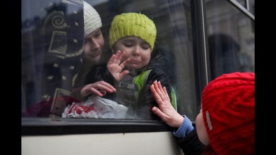 Alexandra, 12, holds her sister Esyea, 6, who cries as she waves at her mother Irina, while members of the Jewish community of Odessa board a bus to flee Russia's invasion of Ukraine, Odessa, Ukraine, March 7, 2022 (REUTERS) Alexandra, 12, holds her sister Esyea, 6, who cries as she waves at her mother Irina, while members of the Jewish community of Odessa board a bus to flee Russia's invasion of Ukraine, Odessa, Ukraine, March 7, 2022 (REUTERS)