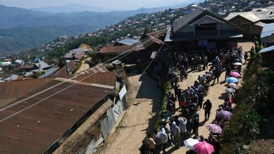 Voters stand in a queue to cast their votes in Ukhrul town, in Manipur, Saturday, March 5, 2022. (AP Photo/Yirmiyan Arthur)(AP)