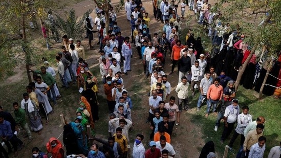 UP election: People stand in a queue to cast their vote at a polling station during the last phase of Uttar Pradesh assembly election in Varanasi. (REUTERS)(HT_PRINT)