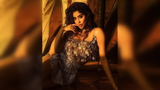 Janhvi Kapoor donned a strappy crop top that had sea shells attached all over and a dazzling short skirt with mermaid print.(Instagram/@janhvikapoor)