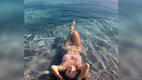In another set of pictures, Disha Patani relaxed in the water like a mermaid donning a pink bikini.(Instagram/@dishapatani)