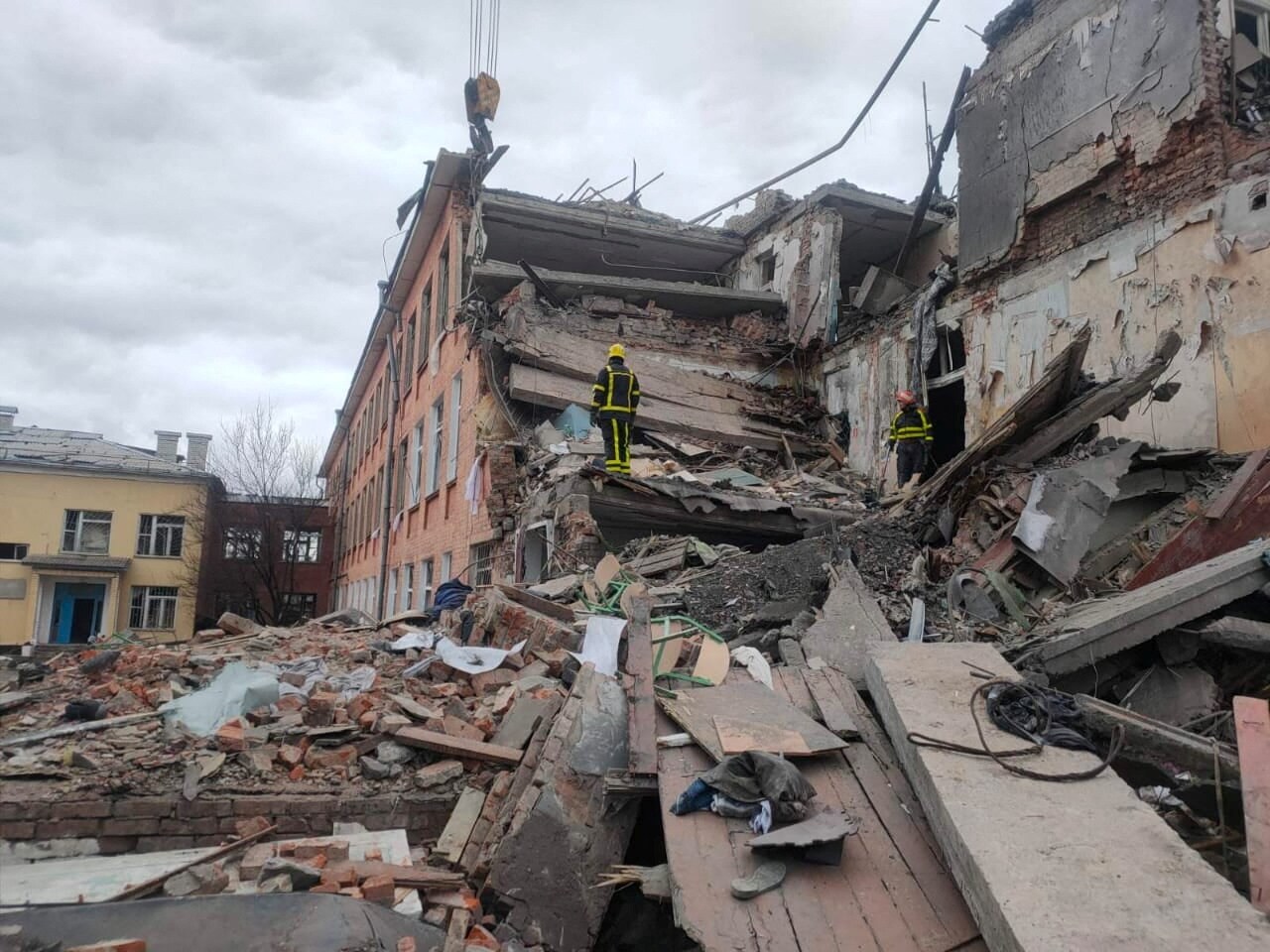 Rescuers remove debris from a school building damaged by shelling, amid the Russian invasion of Ukraine, in Chernihiv, Ukraine, in this handout picture released March 7, 2022. (State Emergency Service of Ukraine/Handout via REUTERS)