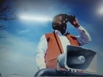 Samajwadi Party candidate from Hastinapur constituency in Meerut district, Yogesh Verma keeps an eye on EVM strong room with binoculars(ANI)