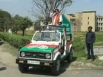 Samajwadi Party candidate from Hastinapur constituency in Meerut district, Yogesh Verma keeps an eye on EVM strong room with binoculars(ANI)