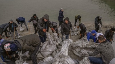 Citizens fill bags with sand for frontlines, along the beach fronting the Black Sea city of Odessa, in the southern Ukraine. Odessa, which Ukraine fears could be the next target of Russia's offensive in the south, is the country's main port and is vital for its economy. (AFP)