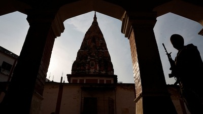 UP election: A policeman stands guard outside a polling booth during the last phase of assembly election in Varanasi in Uttar Pradesh, on March 7 (REUTERS)
