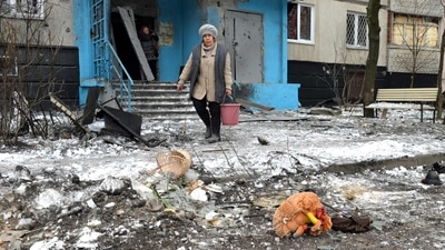 A woman carries a bucket following a shelling in Ukraine's second-biggest city of Kharkiv. (AFP) A woman carries a bucket following a shelling in Ukraine's second-biggest city of Kharkiv. (AFP)