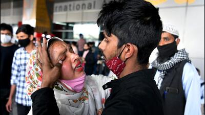 An Indian student embraces his family member upon arrival from war-torn Ukraine after being evacuated under 'Operation Ganga' in New Delhi on Monday. (ANI Photo)