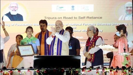 **EDS: HANDOUT PHOTO MADE AVAILABLE FROM PIB ON TUESDAY, MARCH 8, 2022.** Agartala: Union Home and Cooperation Minister Amit Shah during the launch of various women welfare schemes in Tripura. Tripura Chief Minister Biplab Deb is also seen. (PTI Photo)(PTI03_08_2022_000222A) (PTI) **EDS: HANDOUT PHOTO MADE AVAILABLE FROM PIB ON TUESDAY, MARCH 8, 2022.** Agartala: Union Home and Cooperation Minister Amit Shah during the launch of various women welfare schemes in Tripura. Tripura Chief Minister Biplab Deb is also seen. (PTI Photo)(PTI03_08_2022_000222A) (PTI)