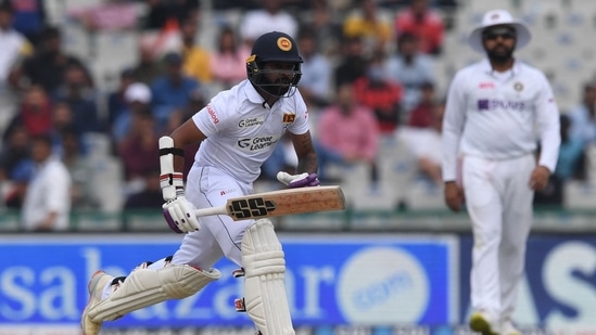 Sri Lanka's wicketkeeper Niroshan Dickwella takes a run during the third day of the first Test cricket match between India and Sri Lanka at the Punjab Cricket Association Stadium in Mohali on March 6, 2022.
