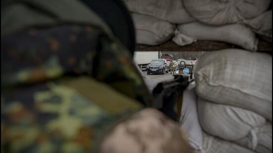 A Ukrainian military personnel monitors a checkpoint in Kyiv. (AP Photo) A Ukrainian military personnel monitors a checkpoint in Kyiv. (AP Photo)