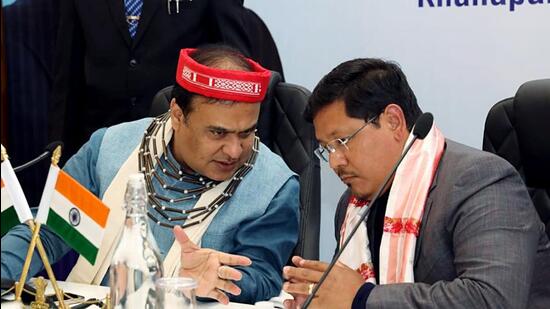 Assam chief minister Himanta Biswa Sarma interacts with Meghalaya chief minister Conrad K Sangma during a meeting on the Meghalaya-Assam border situation at Koinadhara, in Guwahati on Wednesday. (ANI Photo) (ANI)