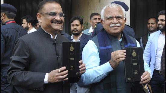 Haryana chief minister Manohar Lal Khattar with additional chief secretary, finance and planning, TVSN Prasad at the Vidhan Sabha in Chandigarh on Tuesday before presenting the state budget for 2022-23. (Keshav Singh/HT)