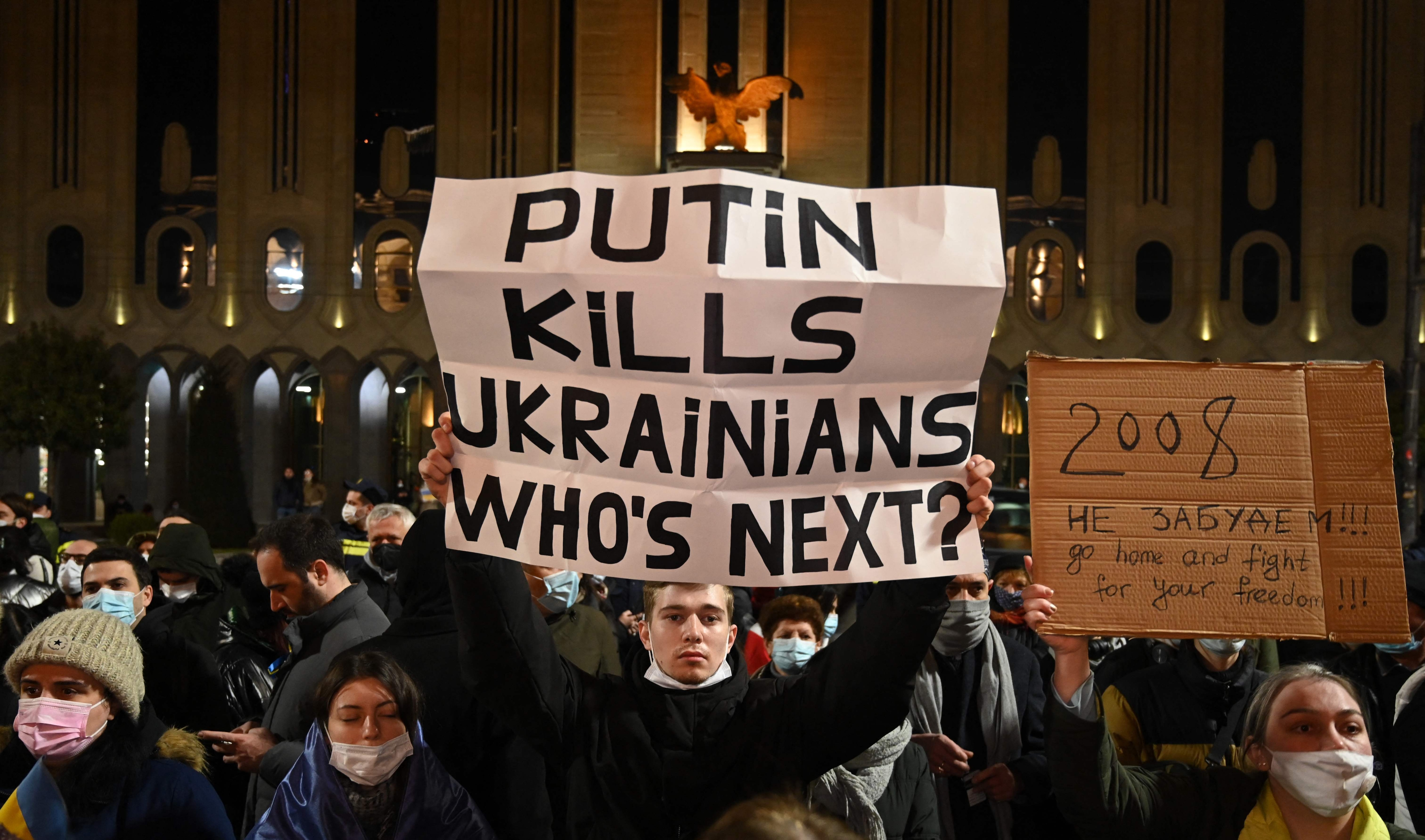 Demonstrators hold posters during a rally in support of Ukraine in Tbilisi on March 7, 2022.&nbsp; (AFP)