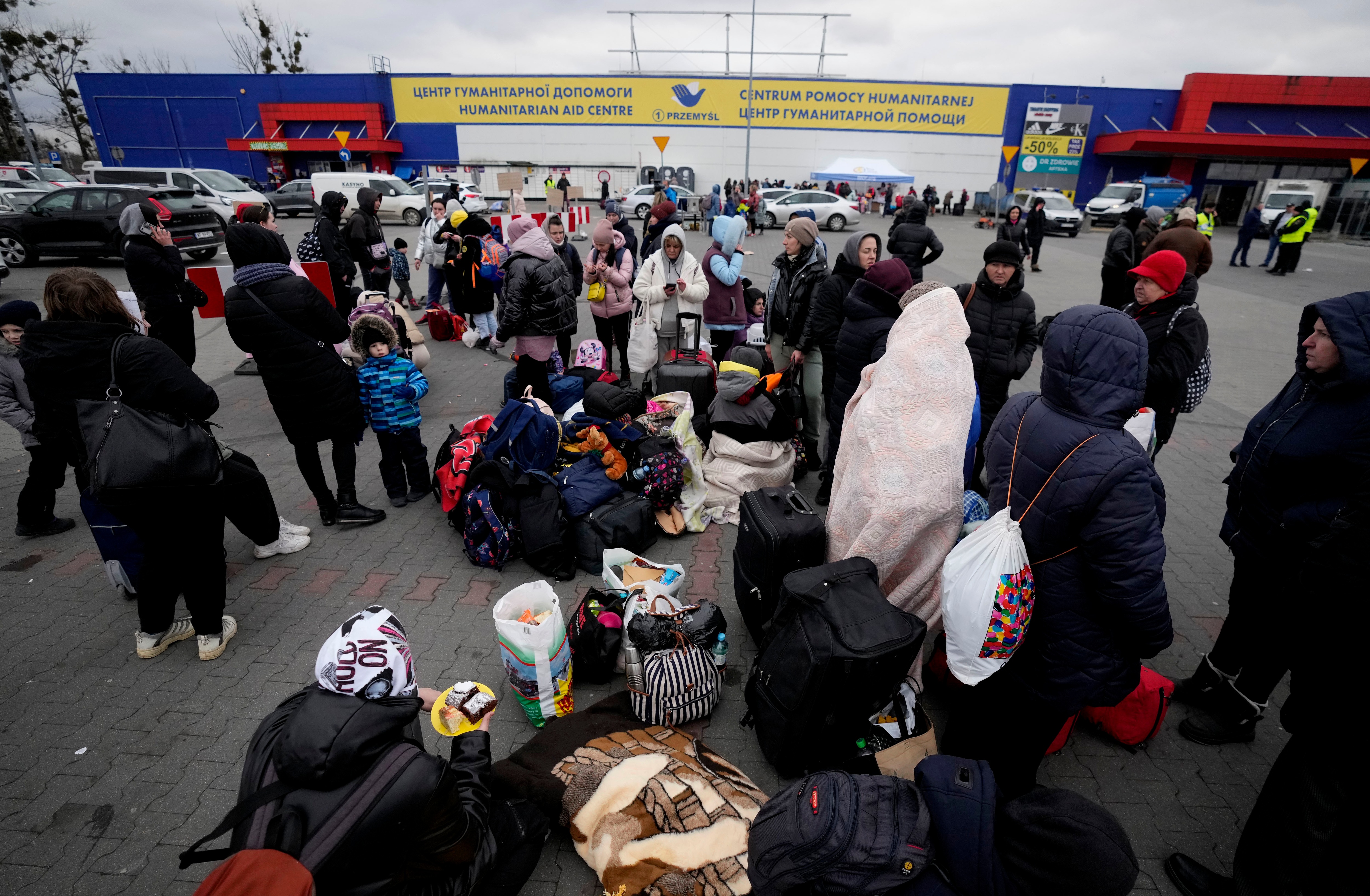 People, fleeing from Ukraine, wait outside a humanitarian aid center in Przemysl, Poland on March 8, 2022.&nbsp; (AP)