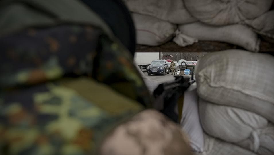 A Ukrainian military personnel monitors a checkpoint in Kyiv. (AP Photo)