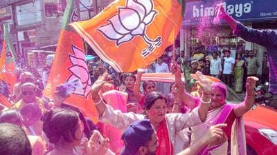 BJP supporters holding party flags, celebrate with colours after the party's lead in the Assam municipal elections, outside the party office, in Dibrugarh on Wednesday. (PTI) BJP supporters holding party flags, celebrate with colours after the party's lead in the Assam municipal elections, outside the party office, in Dibrugarh on Wednesday. (PTI)