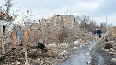 People walk near debris and houses destroyed by shelling, amid Russia's invasion of Ukraine, in Sumy, Ukraine March 8, 2022 in this picture obtained from social media. Andrey Mozgovoy/via REUTERS (Andrey Mozgovoy via REUTERS)
