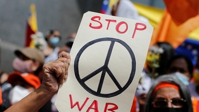 A protestor holds a peace sign during an anti-war protest amid Russia's invasion of Ukraine.