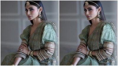 Styled by fashion stylist Rishika Devnani, Mouni accessorised her look with gold and emerald jhumkas and a golden maangtikka. (Instagram/@imouniroy)