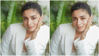 Alia's white dress came with midriff-baring details. The white blazer came detailed in printed buttons near the sleeves and the pockets. (Instagram/@aliabhatt)