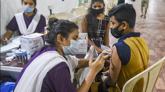 A beneficiary receives a dose of Covid-19 vaccine from a healthworker, at Dahisar in Mumbai. (PTI)
