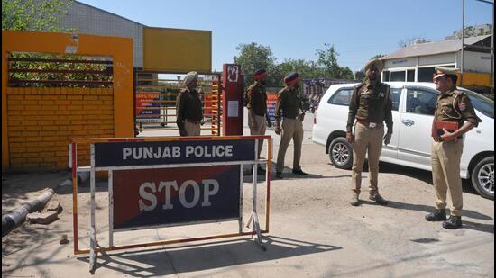 Police personnel stand guard outside the EVM strongroom at Sports Complex, Sector 78, in Mohali on Wednesday. (Ravi Kumar/HT)