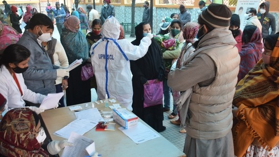 File photo of a health worker collecting sample from a woman.(HT_PRINT)