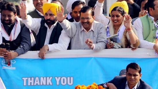 Delhi Chief Minister Arvind Kejriwal, Punjab Aam Aadmi Party (AAP) President, Bhagwant Mann along with others wave to supporters during 'Vijay Yatra' after AAP's victory in the Chandigarh Municipal Corporation elections. (ANI Photo)(Ajay Jalandhari)