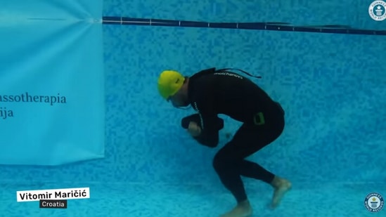 The image, taken from the YouTube video posted by Guinness World Records, shows the man walking underwater to create record. (YouTube/@Guinness World Records)