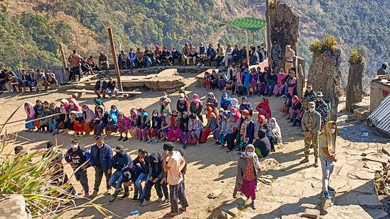 People wait outside a polling station to cast their votes, during the repolls of a few Manipur Assembly constituencies.(PTI)