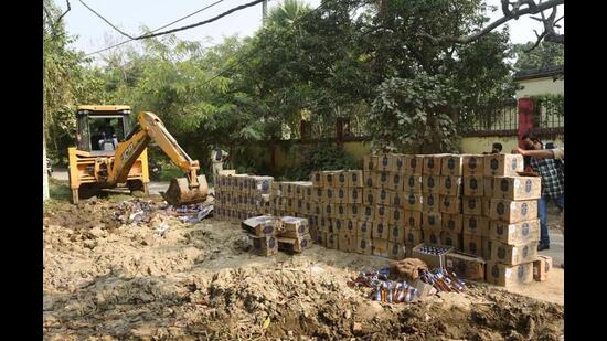 Seized liquor bottles being destroyed in Patna. (HT Photo)
