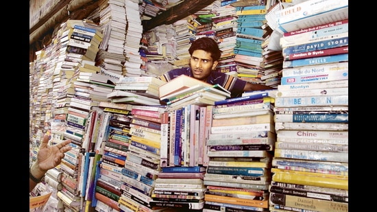 Behind a wall of books: At a second hand book store (Dijeshwar Singh)