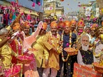 BJP supporters celebrate with flowers, as the party heads to a landslide victory in the UP Assembly elections, in Varanasi on March 10, 2022.&nbsp;