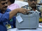 File photo of officials inspecting an Electronic Voting Machine (EVM) during a votes counting process at a booth. File photo of officials inspecting an Electronic Voting Machine (EVM) during a votes counting process at a booth.