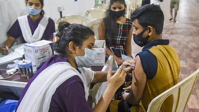 A beneficiary receives a dose of Covid-19 vaccine from a healthworker, at Dahisar in Mumbai.&nbsp; (PTI)