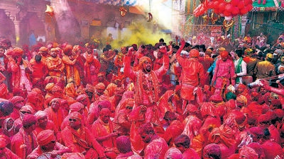 BJP supporters smeared in colours celebrate in Barsana village of Uttar Pradesh on Thursday. (AFP) BJP supporters smeared in colours celebrate in Barsana village of Uttar Pradesh on Thursday. (AFP)