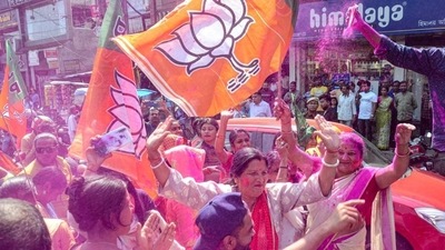 BJP supporters holding party flags, celebrate with colours after the party's lead in the Assam municipal elections, outside the party office, in Dibrugarh on Wednesday. (PTI) BJP supporters holding party flags, celebrate with colours after the party's lead in the Assam municipal elections, outside the party office, in Dibrugarh on Wednesday. (PTI)