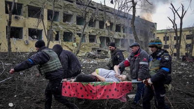 Ukrainian emergency employees and volunteers carry an injured pregnant woman from a maternity hospital that was damaged by shelling in Mariupol, Ukraine. (AP) Ukrainian emergency employees and volunteers carry an injured pregnant woman from a maternity hospital that was damaged by shelling in Mariupol, Ukraine. (AP)