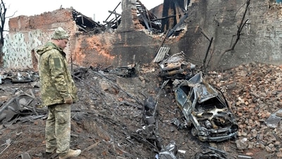 A Ukrainian serviceman looks at destructions following a shelling in Ukraine's second-biggest city of Kharkiv. (AFP)