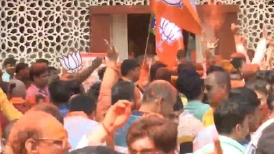 BJP workers play holi at party office in Lucknow as official trends show the party sweeping UP polls. (ANI)